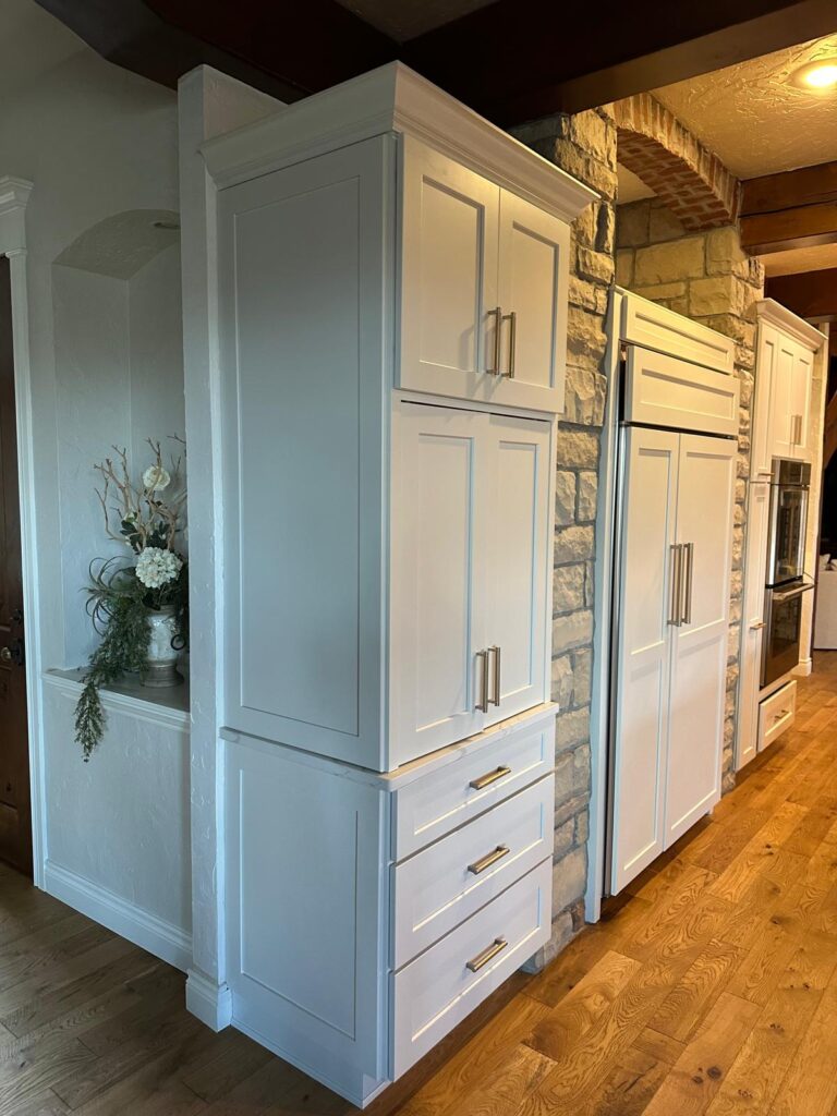 Luxury kitchen island with a marble countertop and custom handcrafted cabinetry by Max Craft